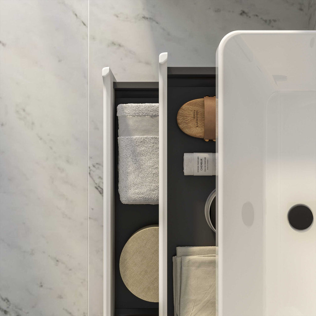 Stylish bathroom organiser drawer with neatly folded towels, wooden accessories, and toiletries, showcasing modern bathroom storage solutions for a sleek, clutter-free space.