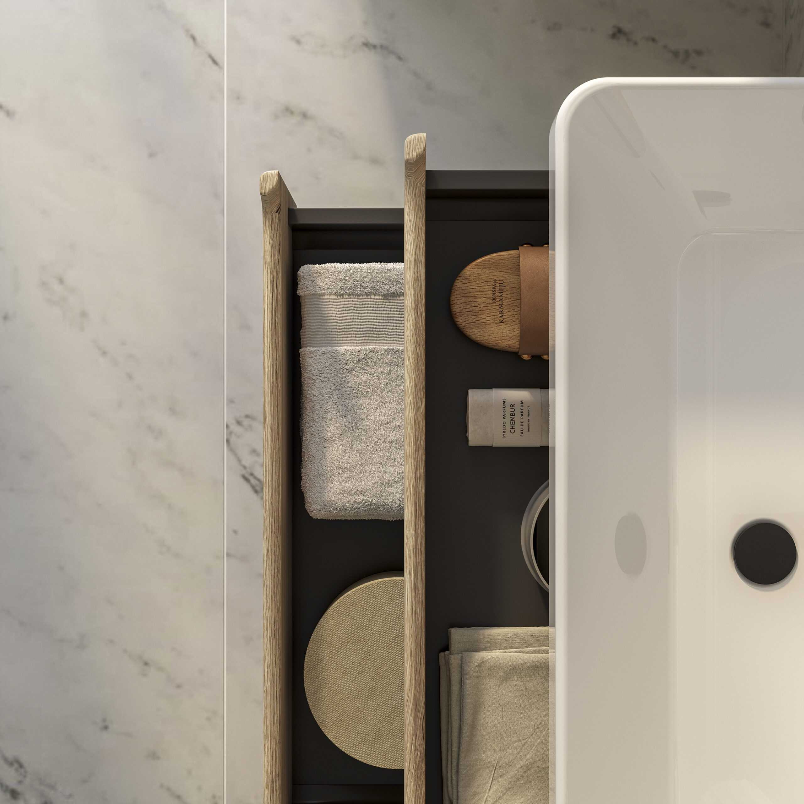 Luxurious modern bathroom countertop with neatly arranged towels, skincare items, and accessories on a sleek, marble surface for stylish and functional bathroom storage.