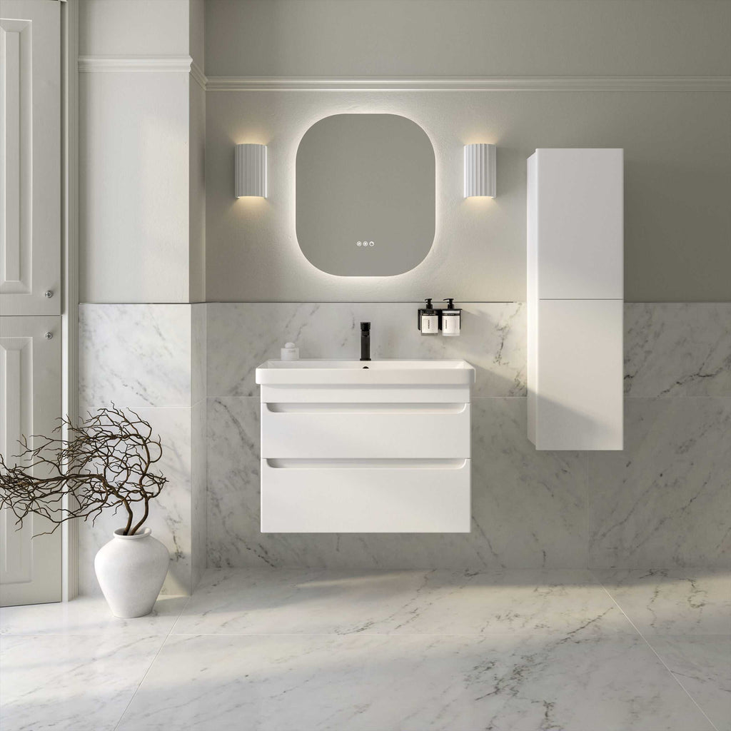 Modern white bathroom vanity with integrated sink, wall-mounted mirror with backlit lighting, and minimalist storage cabinet on marble wall and floor, creating a sleek and elegant bathroom design.
