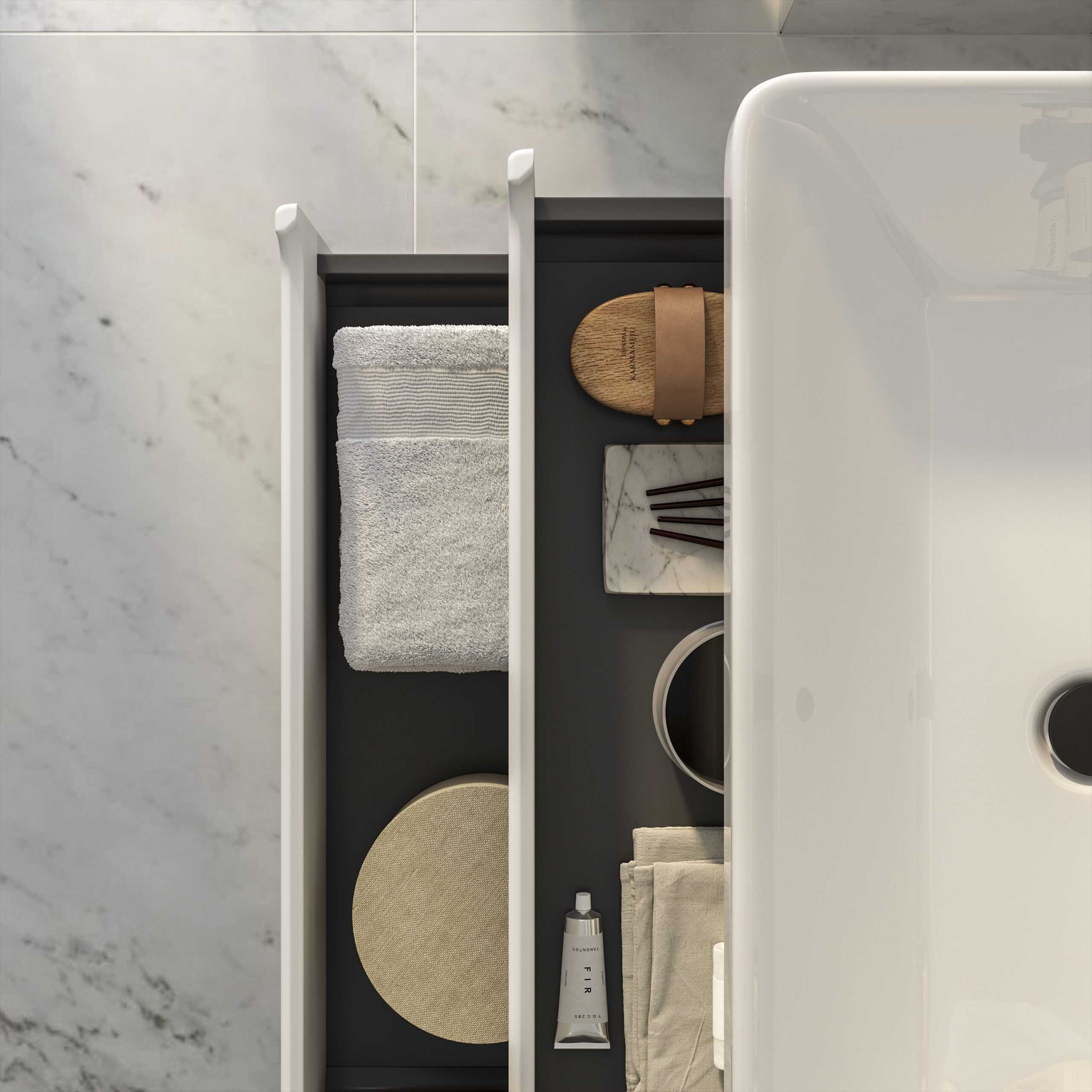 Sleek modern bathroom storage drawer with neatly organised towels, accessories, and toiletries, showcasing stylish bathroom design and effective space utilisation.