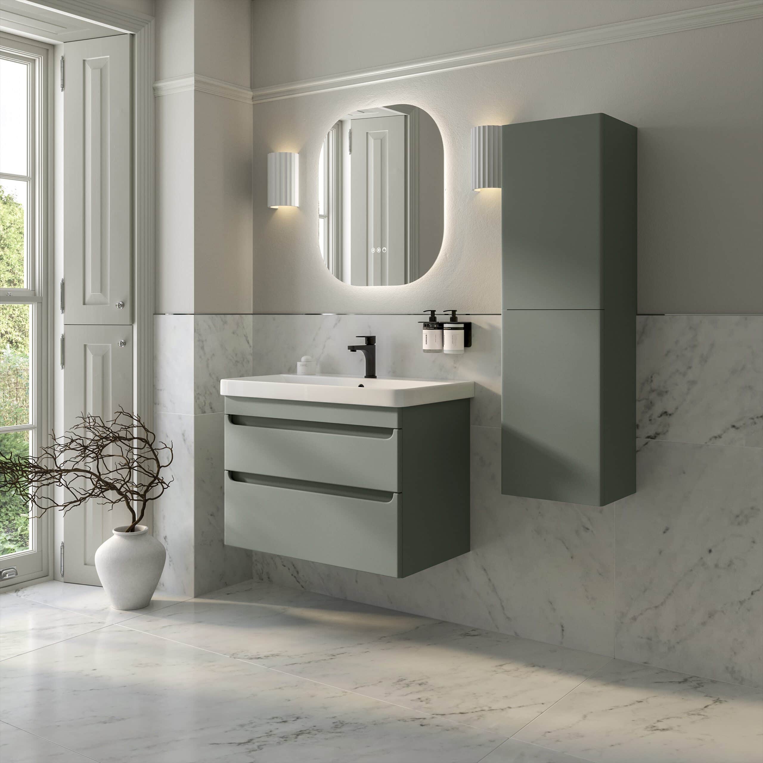 Sleek modern bathroom with floating grey vanity unit, wall-mounted cabinet, oval mirror, and contemporary lighting in a bright, marble-tiled space featuring large window.
