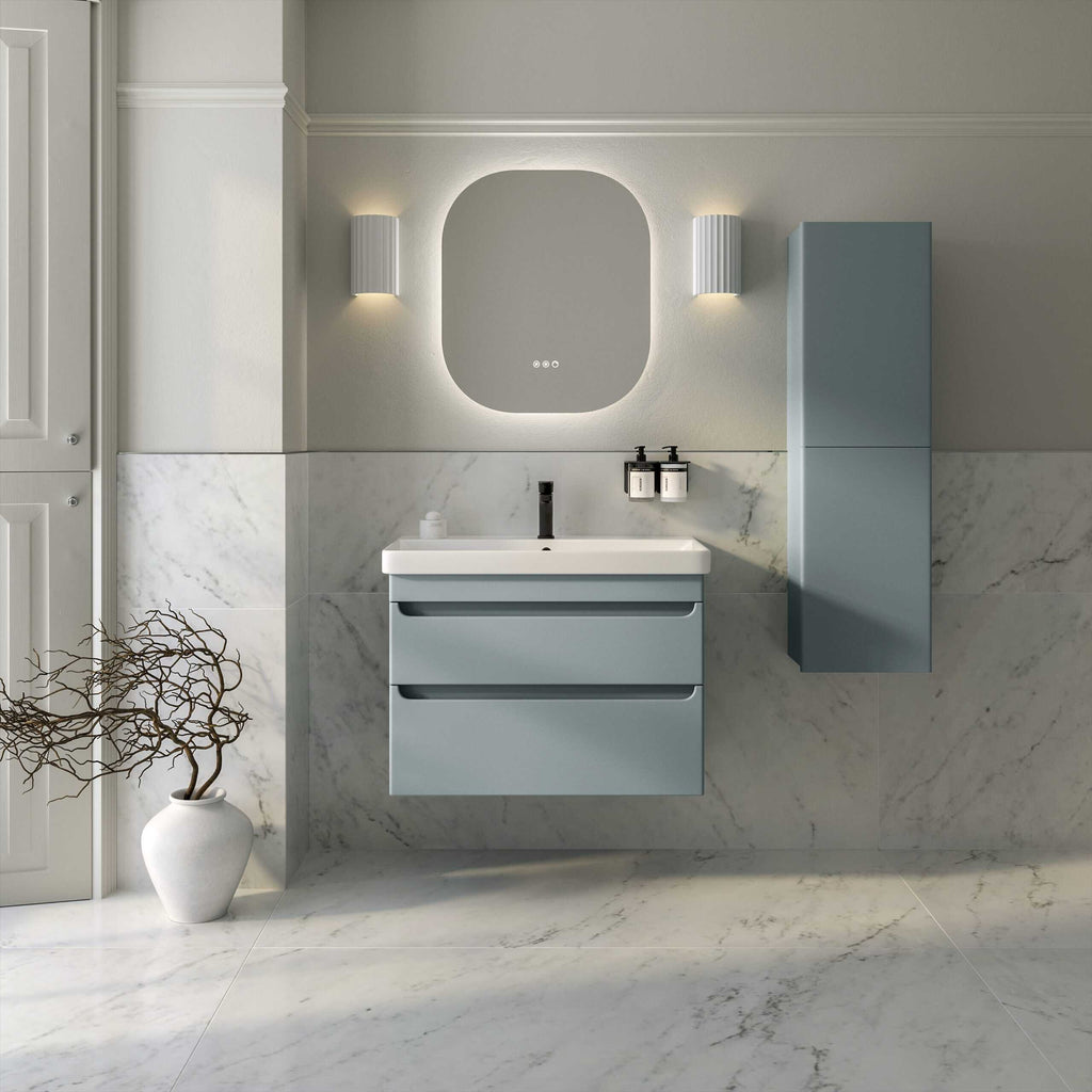 Modern minimalist bathroom with light blue vanity unit and matching wall cabinet, marble tiled walls and floors, illuminated mirror, and sleek black fixtures, creating a clean and contemporary bathroom design.