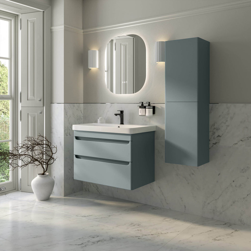 Modern bathroom vanity with a blue floating cabinet, white sink, and minimalist black fixtures, complemented by a sleek mirror and wall-mounted storage, set in a bright, marble-tiled space with natural light.