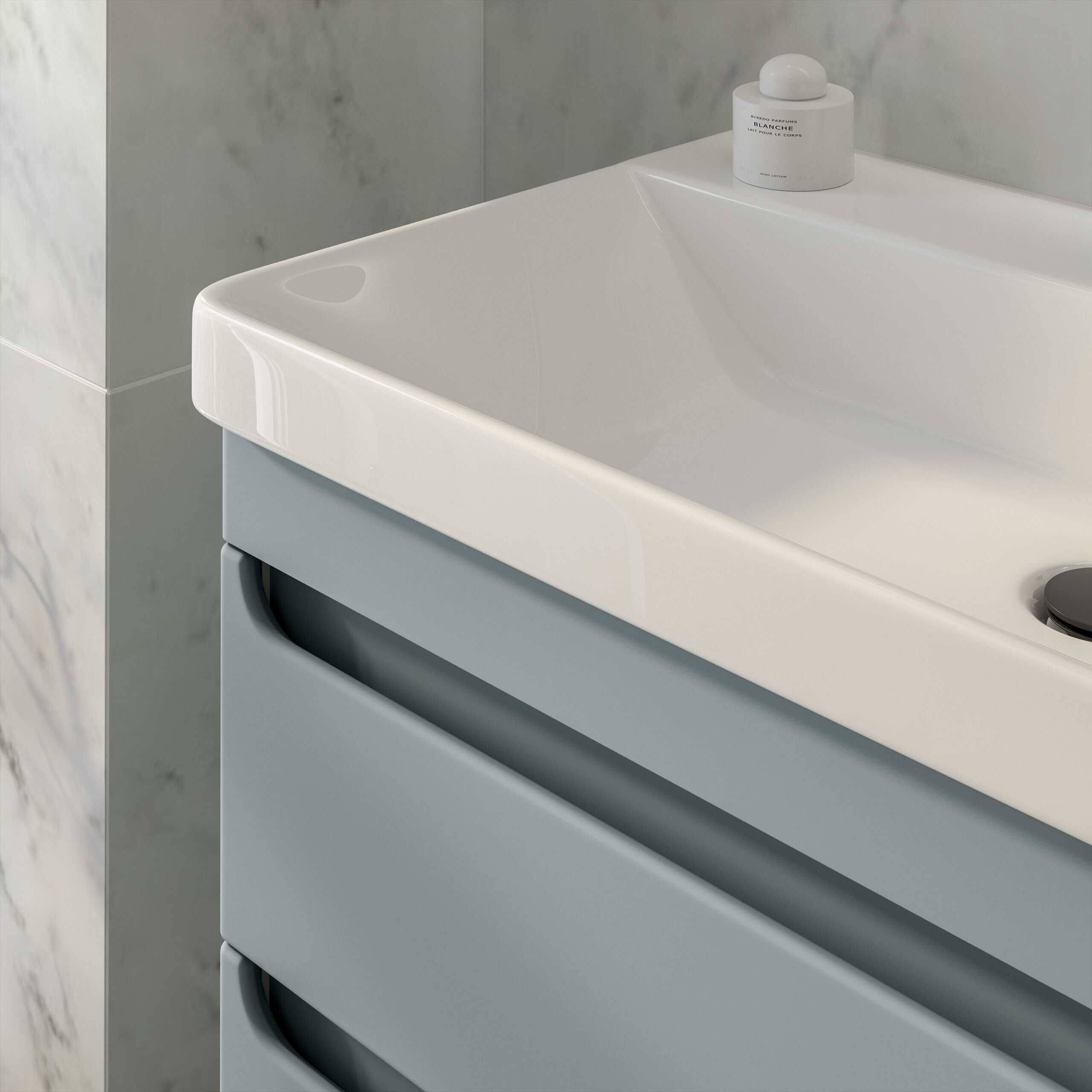 Sleek white bathroom sink with modern grey cabinetry, minimalist design, and a stylish soap dispenser on the countertop. Perfect for contemporary bathroom upgrades.