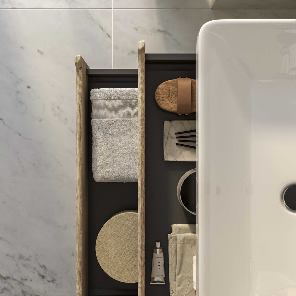 Soft beige towel neatly folded on a modern bathroom shelf with natural wood accents, stylish decor, and elegant toiletries.