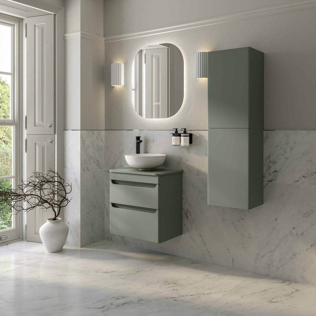 Sleek modern bathroom with a floating green vanity, wall-mounted mirror, and marble walls, creating a luxurious and contemporary bathroom design.