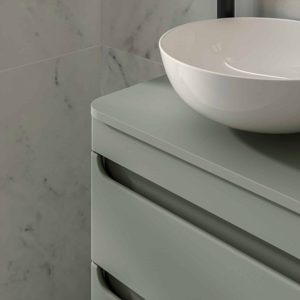 Sleek modern bathroom vanity with a round white vessel sink, smooth matte finish, and marble tiled wall background perfect for contemporary bathroom design.
