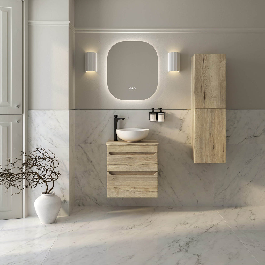 Modern minimalist bathroom interior with light wood vanity, vessel sink, round mirror, and marble wall and floor tiles, creating a sleek and elegant bathroom design.