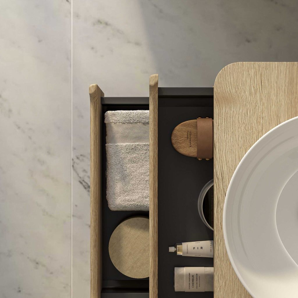 Minimalist bathroom storage with towels, toiletries, and wooden accents in a modern bathroom setting.