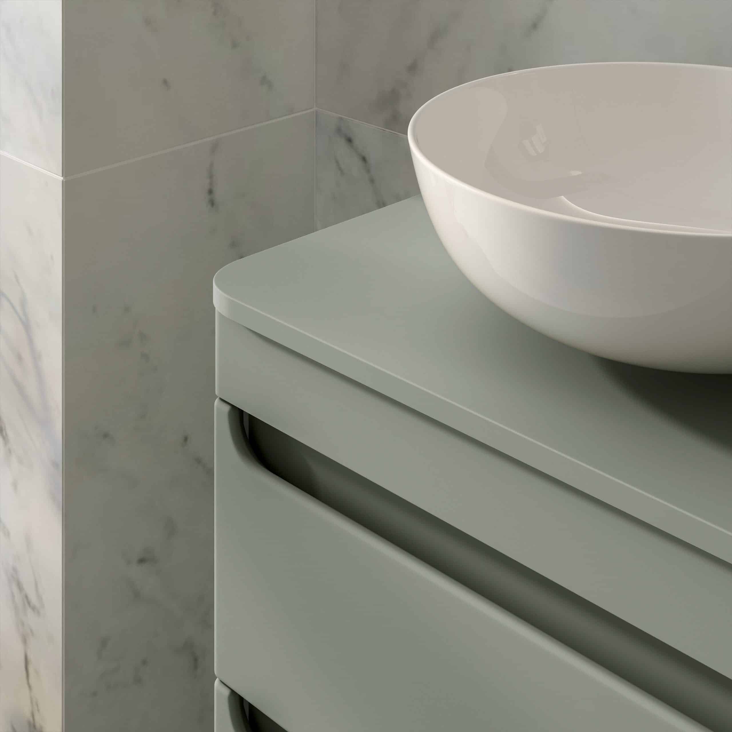 Sleek modern bathroom vanity with matte grey finish and rounded handle design, topped with stylish white vessel sink, set against marble tiled wall for contemporary bathroom decor.