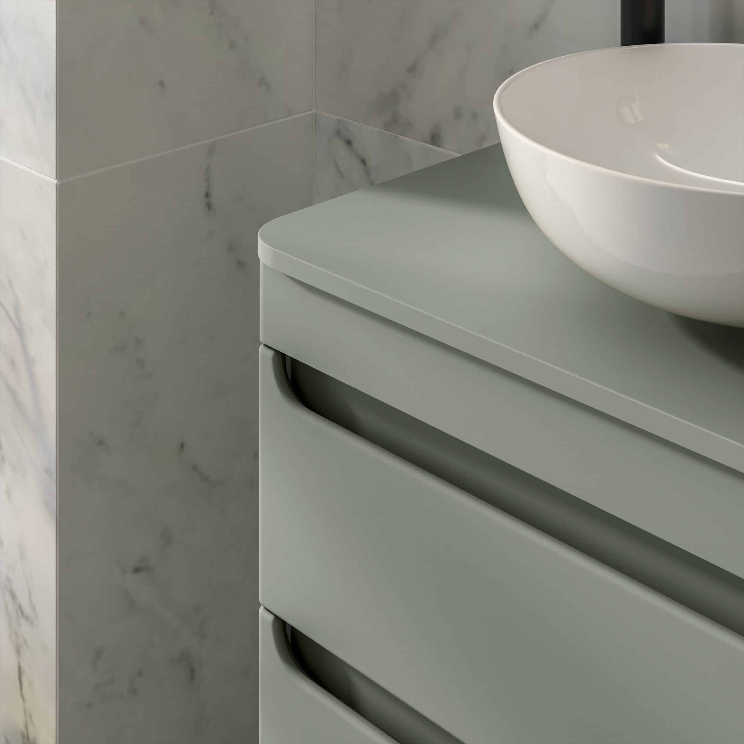 Sleek modern bathroom vanity with a white vessel sink, minimalist design, soft muted green colour, against a marble tiled wall, showcasing stylish and functional bathroom furniture from Bubly Bathrooms.