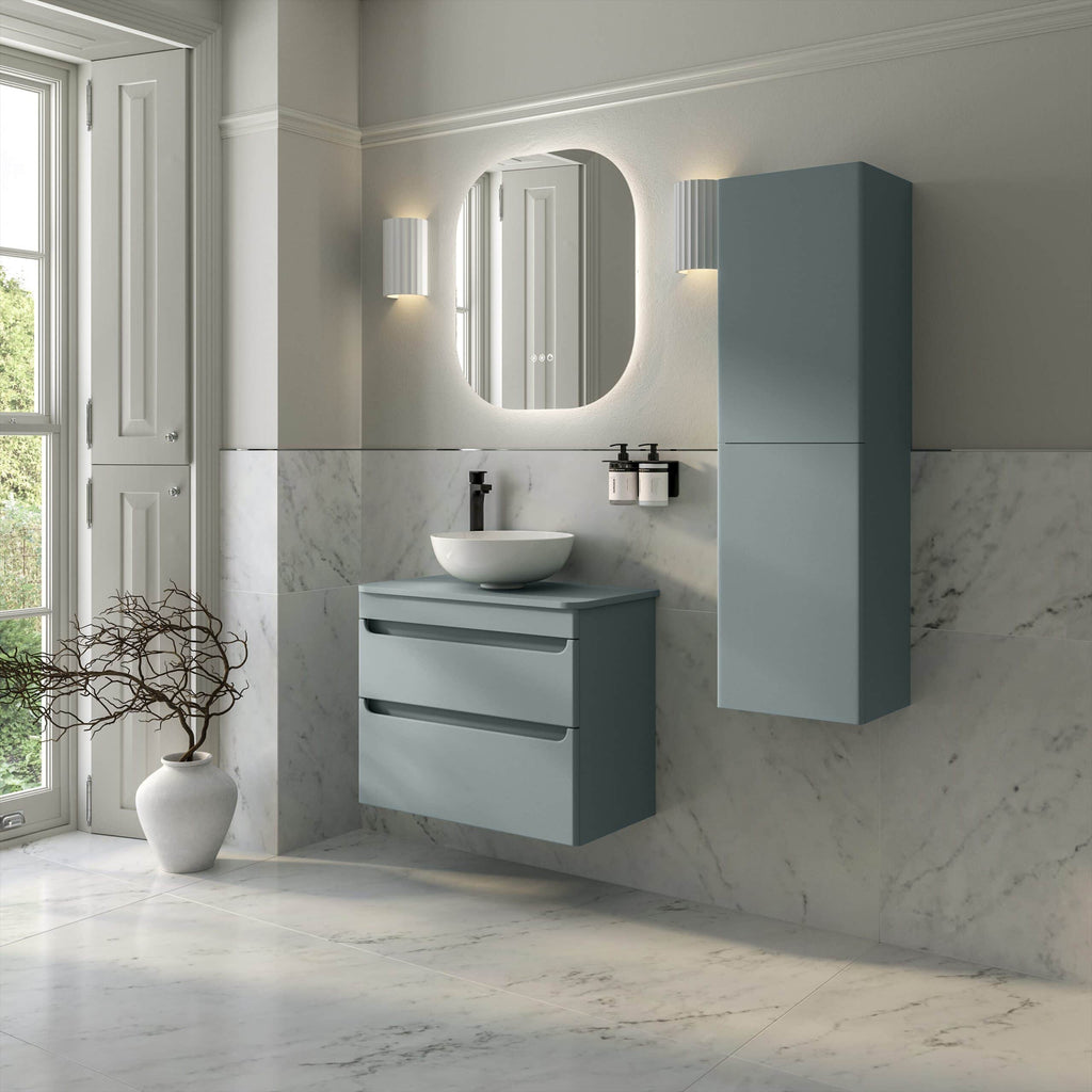 Sleek modern bathroom with blue-grey vanity unit, wall-mounted storage cabinet, marble tiling, oval mirror, and minimalist lighting, showcasing contemporary bathroom design ideas.