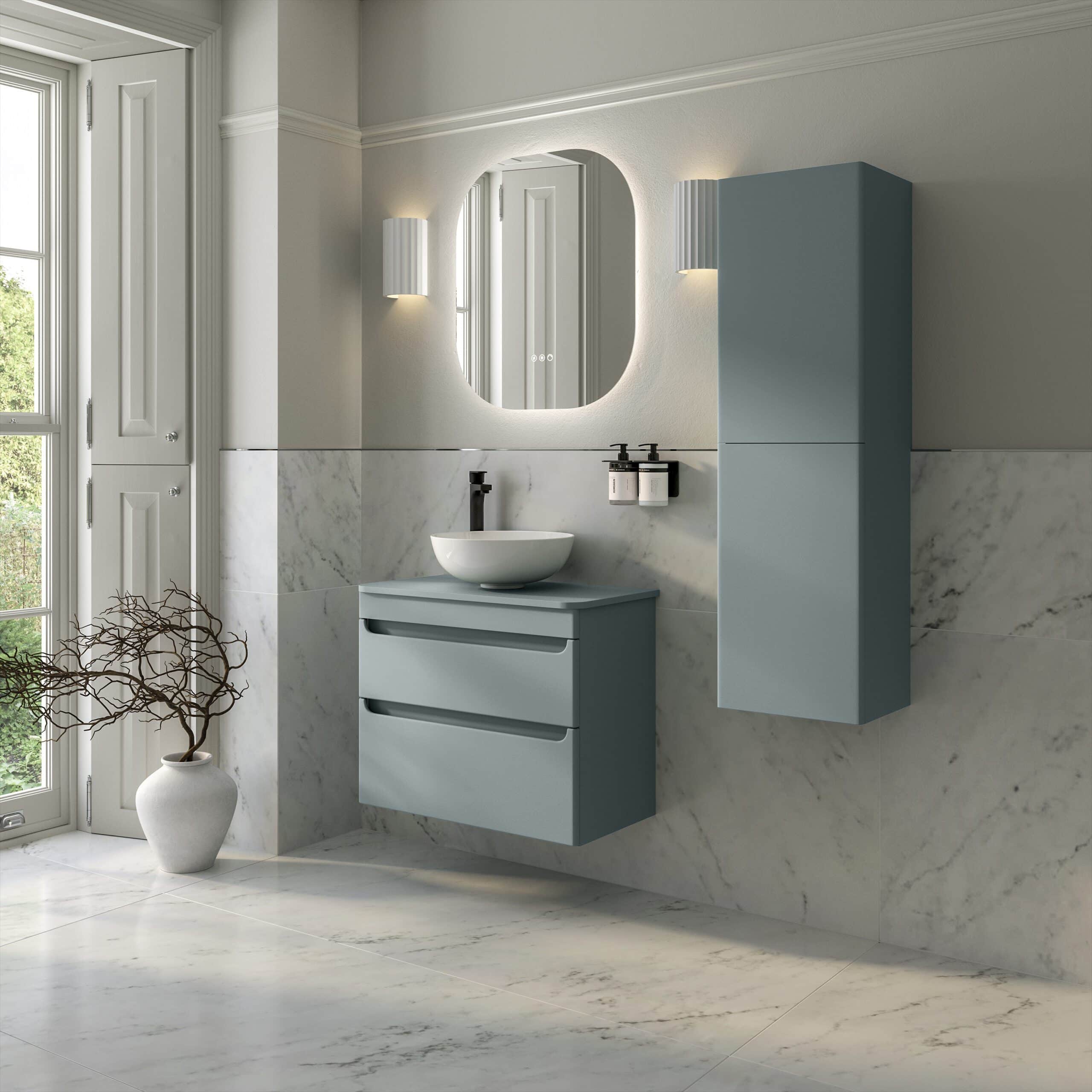 Sleek modern bathroom with blue-grey vanity unit, wall-mounted storage cabinet, marble tiling, oval mirror, and minimalist lighting, showcasing contemporary bathroom design ideas.