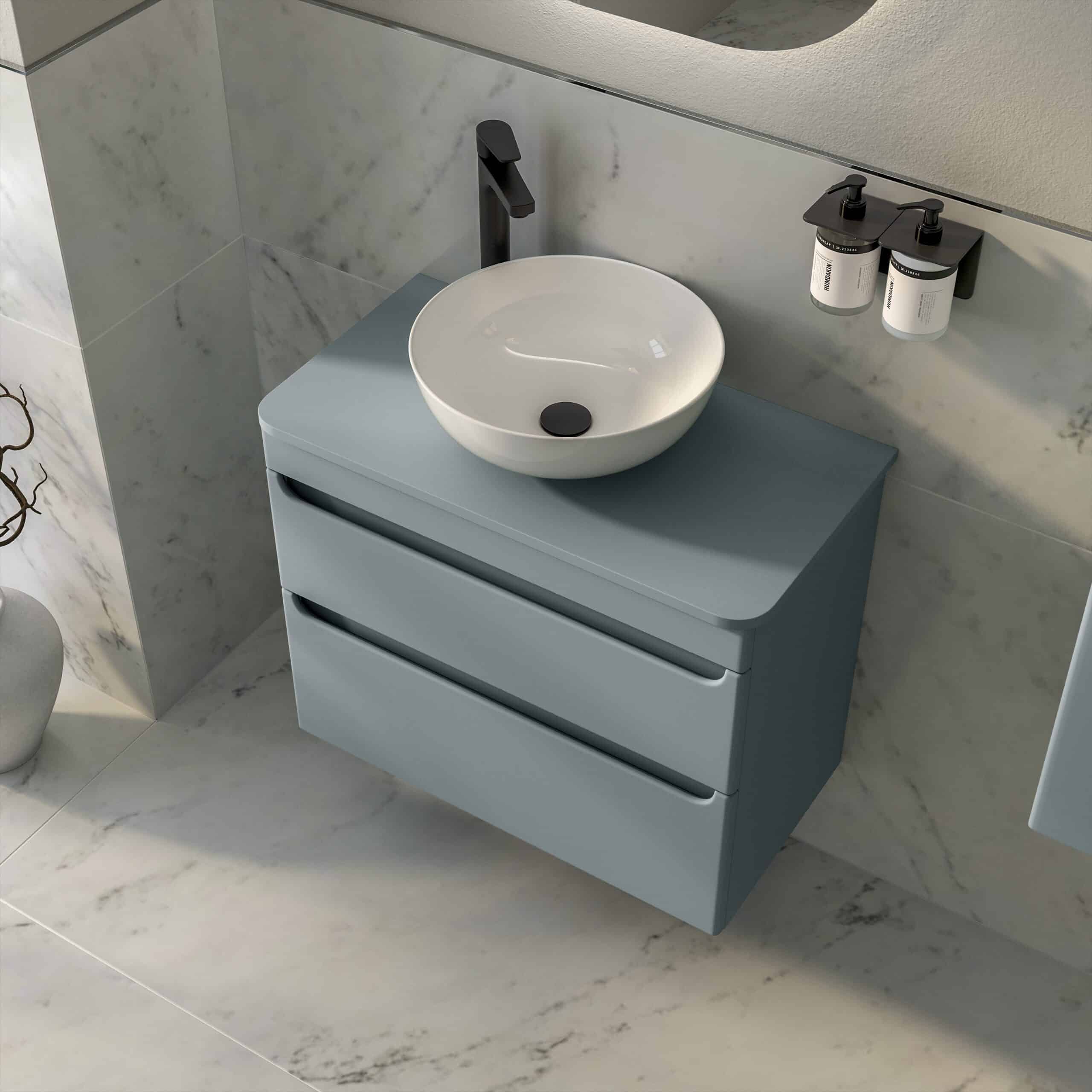 Contemporary blue bathroom vanity with a round ceramic vessel sink, black faucet, and modern wall-mounted soap dispensers, perfect for stylish bathroom decor.