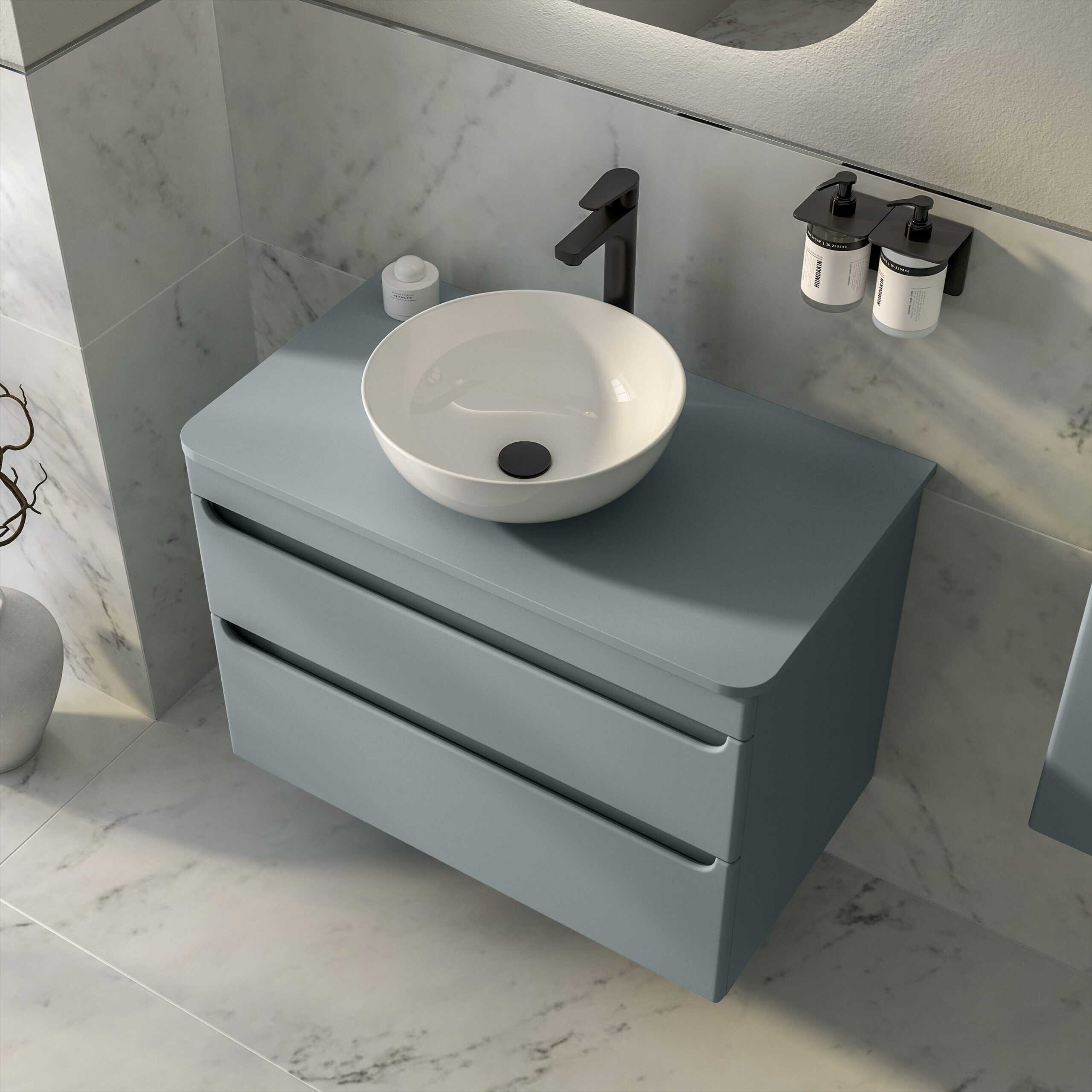 Sleek modern floating bathroom vanity with a round vessel sink, matte black fixtures, and minimalist storage drawers in a contemporary bathroom setting.