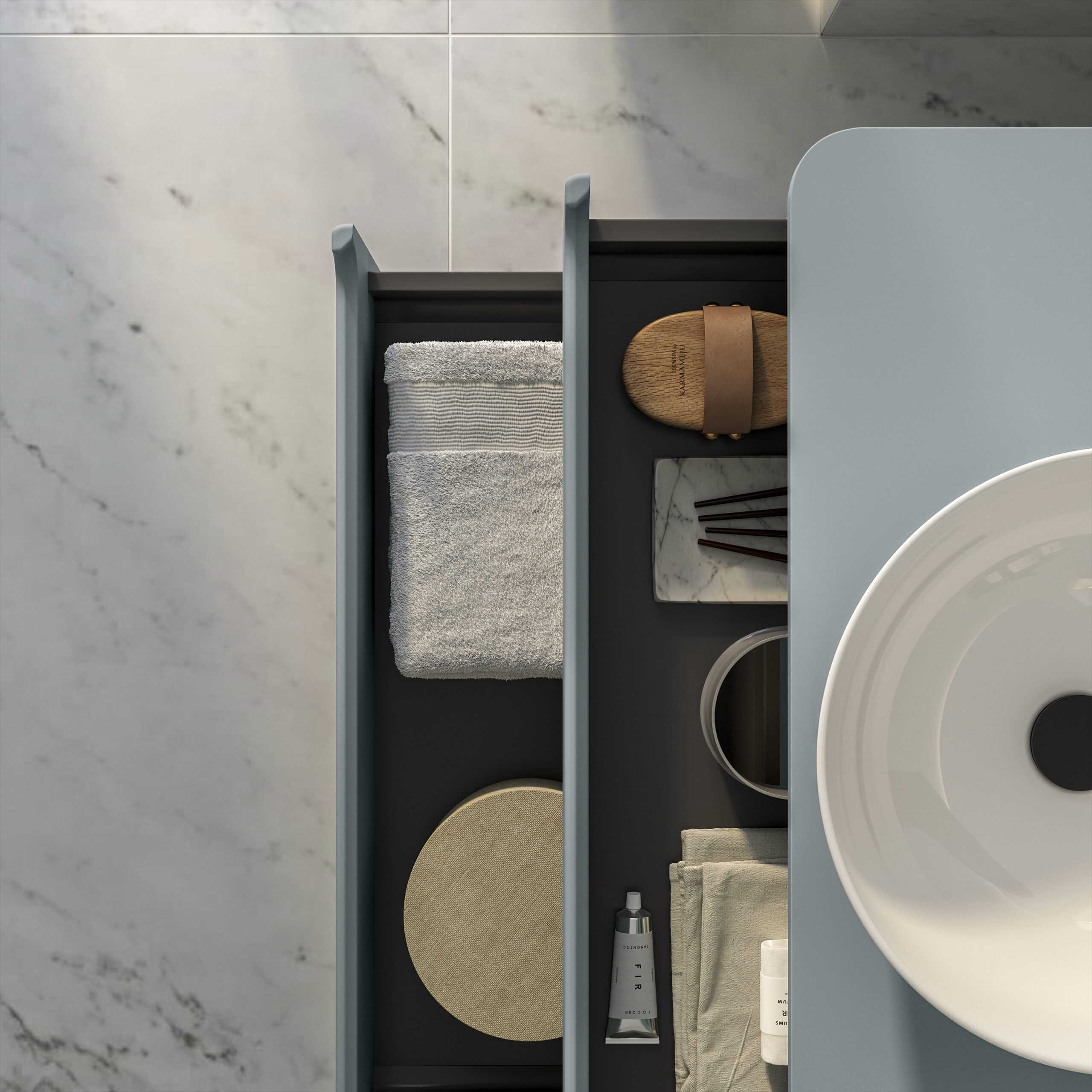 Soft grey bathroom drawer with neatly arranged towels, skincare products, and accessories, showcasing modern bathroom organisation and design.