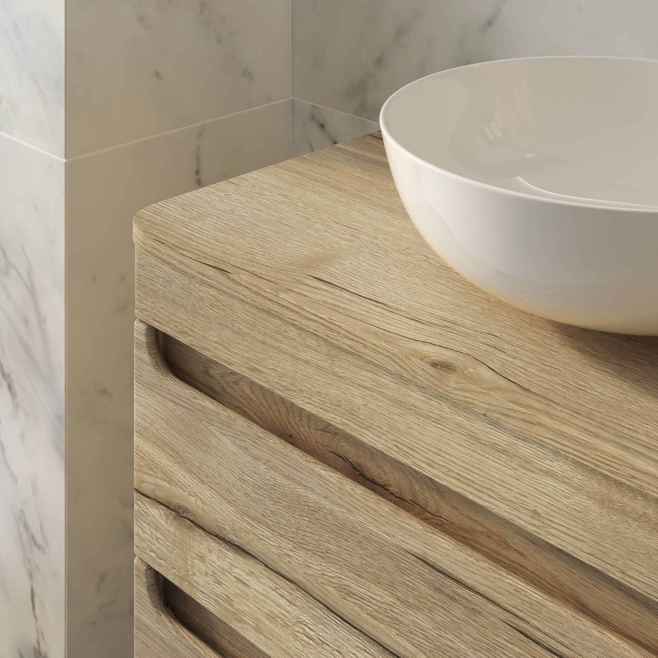 Rustic wooden bathroom vanity with a sleek white vessel sink on top, accented by marble wall tiles for a modern yet natural bathroom design.