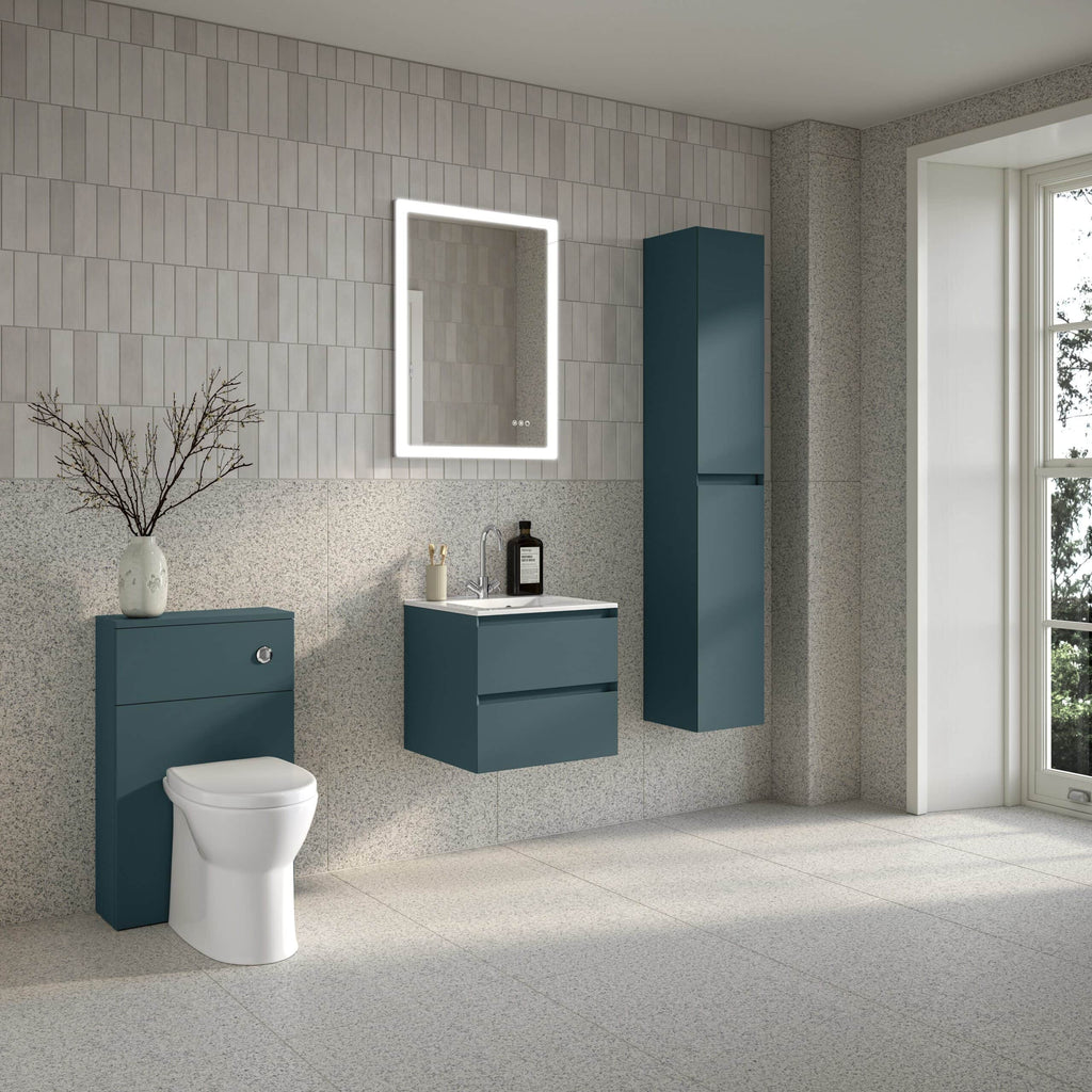 Modern blue bathroom vanity units with a wall-mounted mirror, tall storage cabinet, and contemporary toilet set against a textured wall in a stylish, minimalist bathroom.