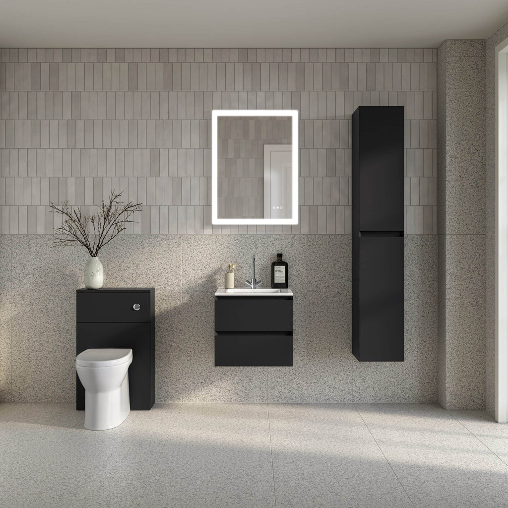 Modern black bathroom units with a white toilet, wall-mounted sink, illuminated mirror, and storage cabinets on a grey textured tiled wall, showcasing contemporary bathroom design.