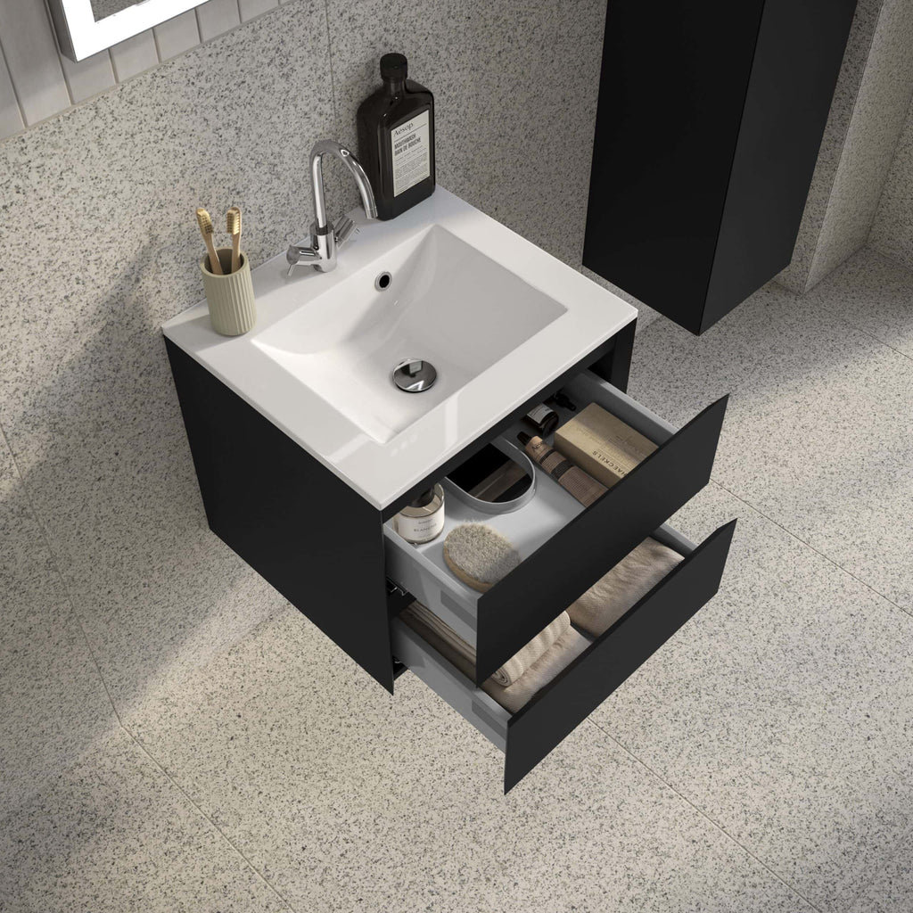 Sleek black bathroom vanity with white ceramic sink, open drawers displaying towels, toiletries, and grooming essentials, modern design, perfect for contemporary bathroom interiors.