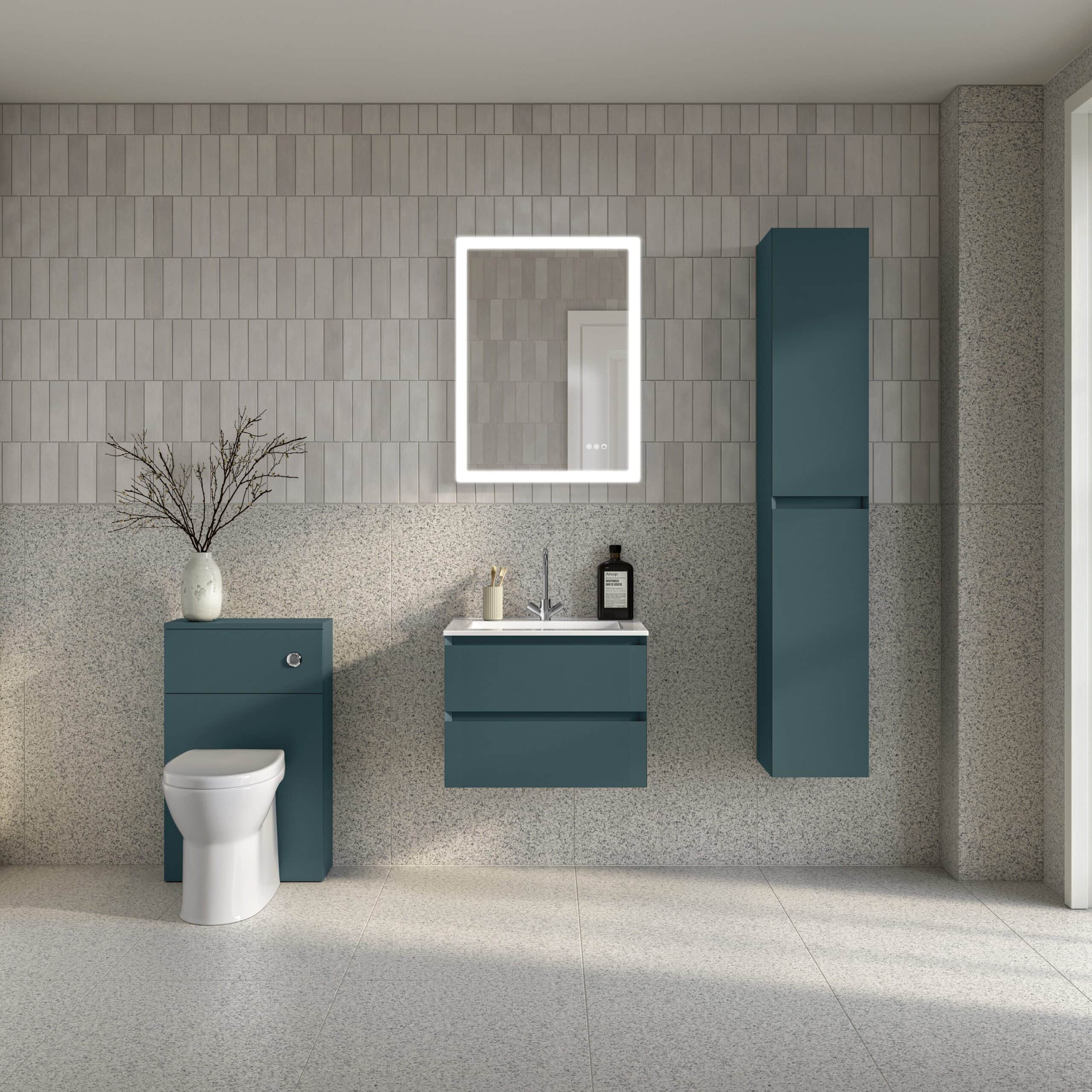 Modern bathroom with blue vanity units, wall-mounted mirror with LED lighting, white toilet, and minimalistic decor, showcasing contemporary bathroom design and storage solutions.
