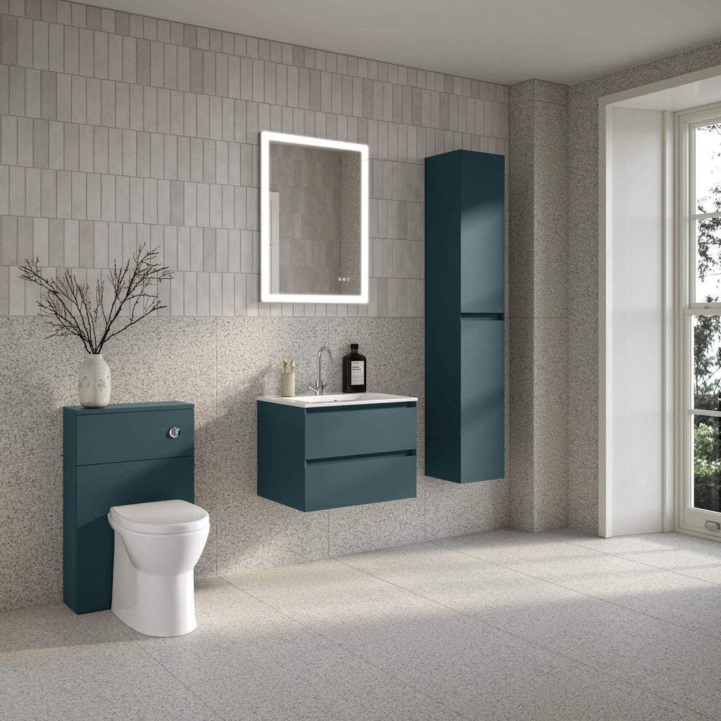 Sleek blue bathroom vanity units with white ceramic sink, modern mirror with LED lighting, compact WC, tall storage cabinet, and minimalist décor in a contemporary bathroom design.