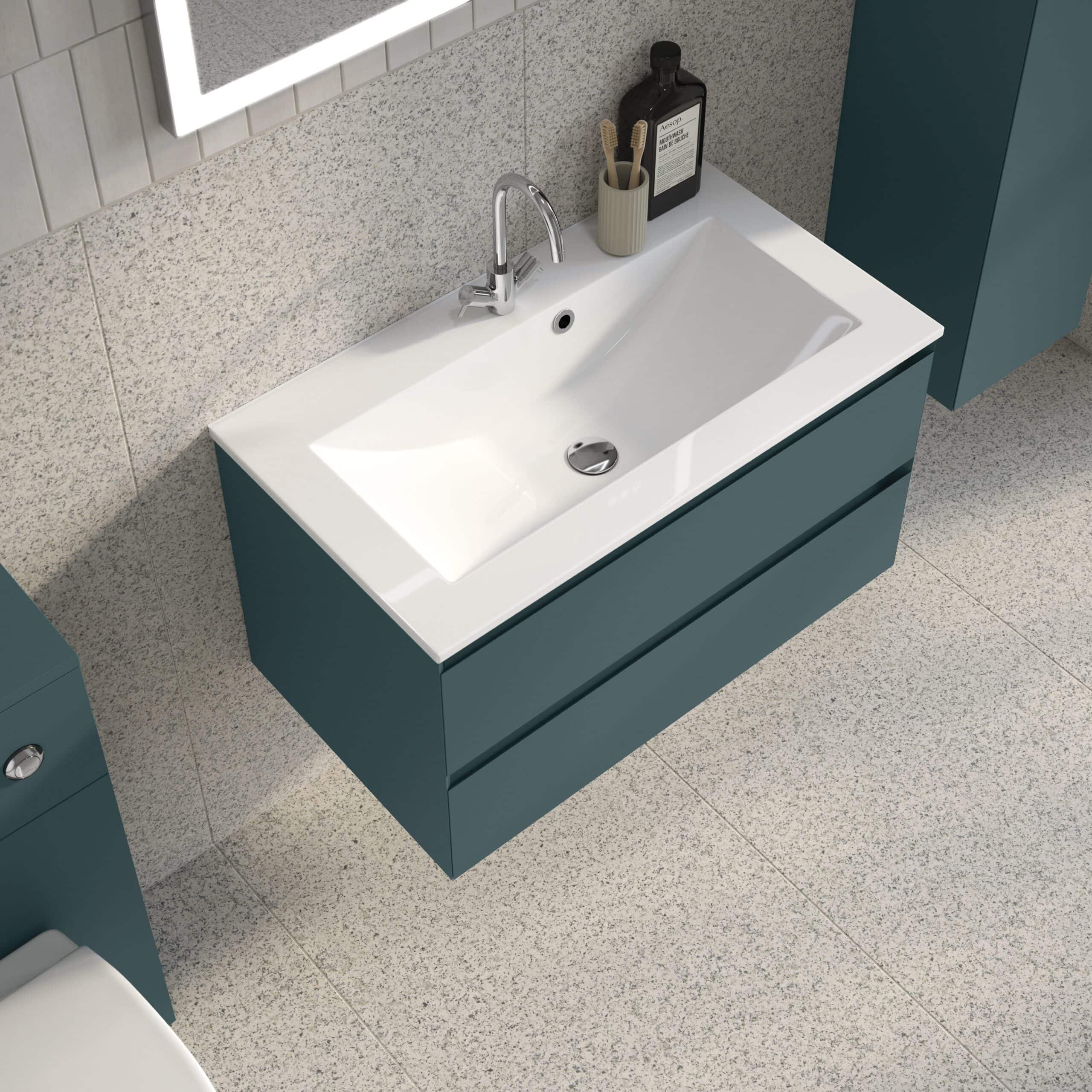 Sleek modern bathroom vanity with a white ceramic sink and blue cabinet, ideal for contemporary bathroom designs, featuring ample storage and stylish details.