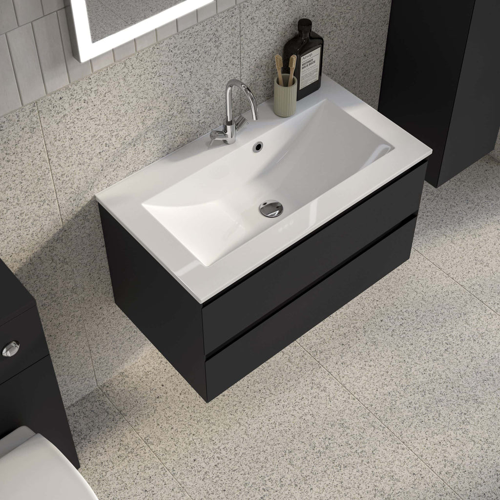 Sleek black bathroom vanity with integrated white ceramic sink, modern chrome tap, and minimalist design for contemporary bathrooms.