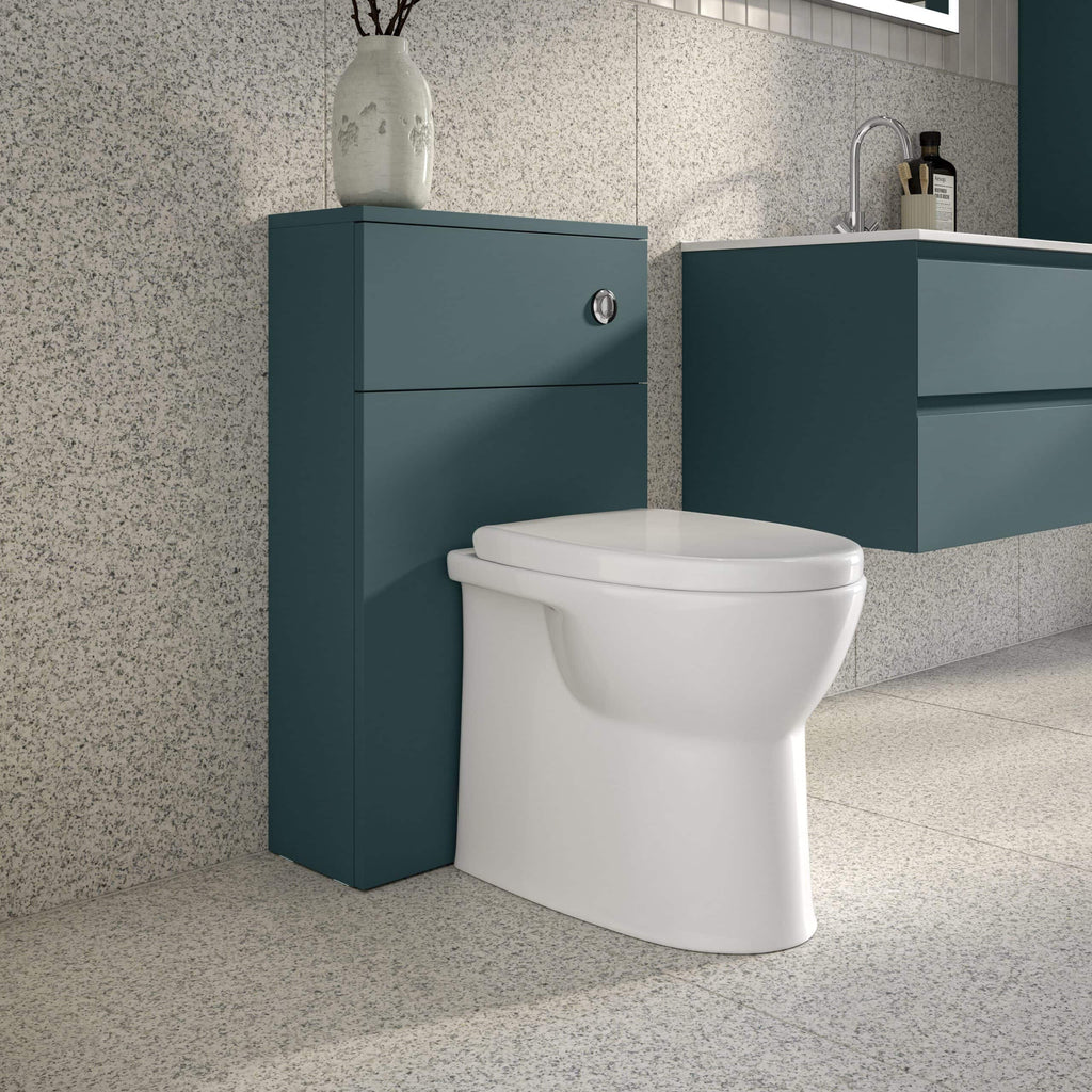 Sleek modern bathroom with white toilet and teal cabinetry, featuring a minimalist design, textured wall tiles, and contemporary fixtures for a stylish and functional space.