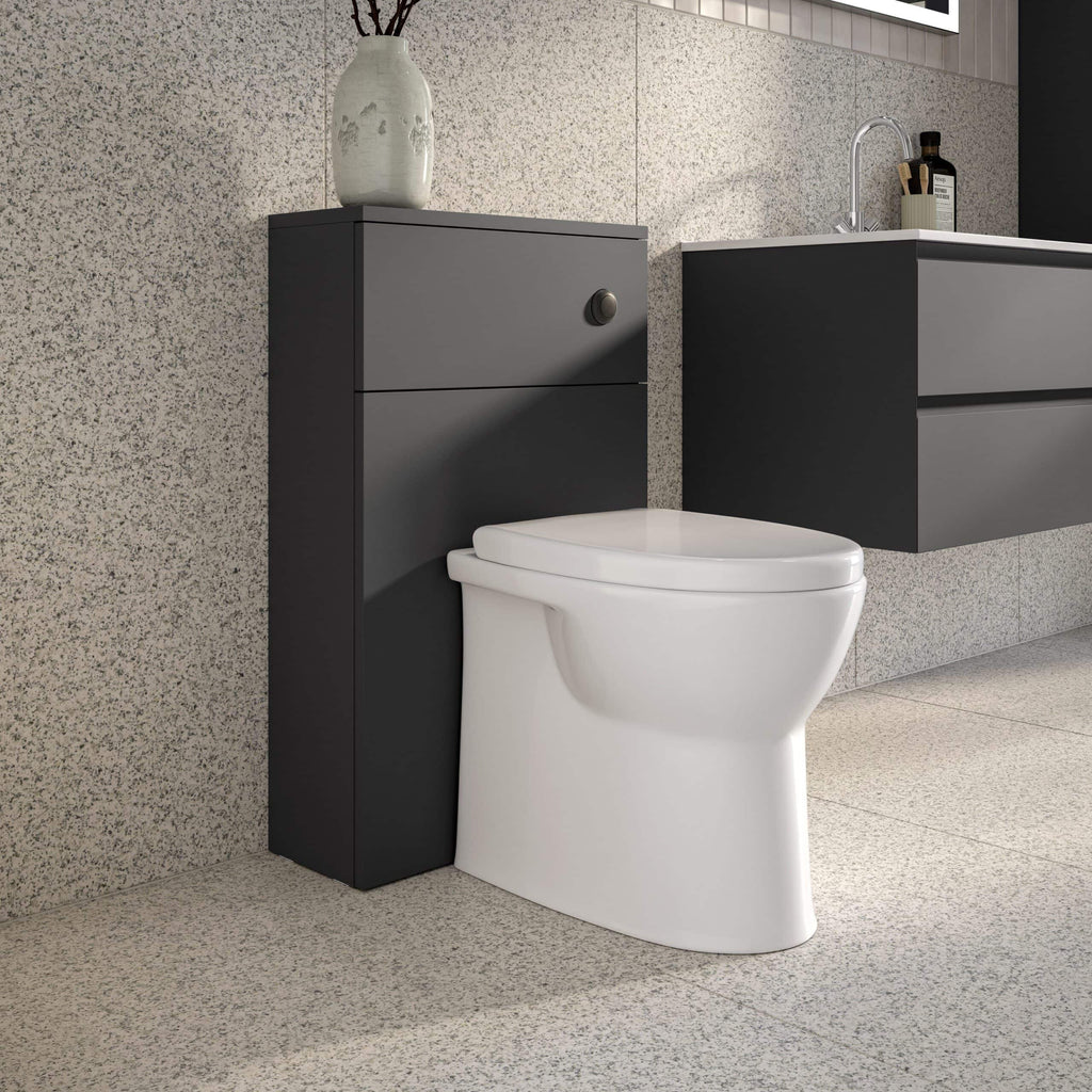 Modern close-coupled toilet with concealed cistern and floating vanity unit in a contemporary bathroom design.