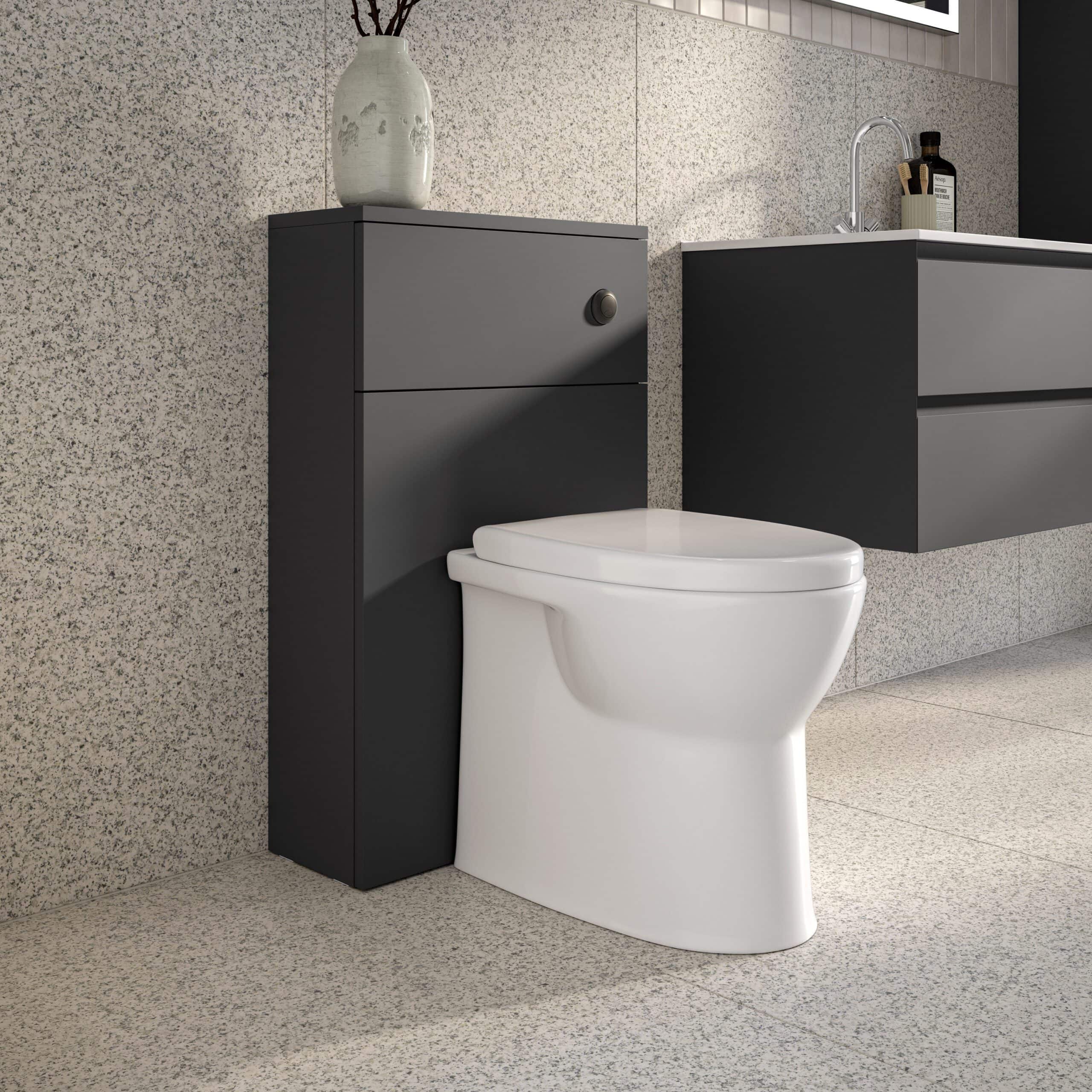 Modern close-coupled toilet with concealed cistern and floating vanity unit in a contemporary bathroom design.