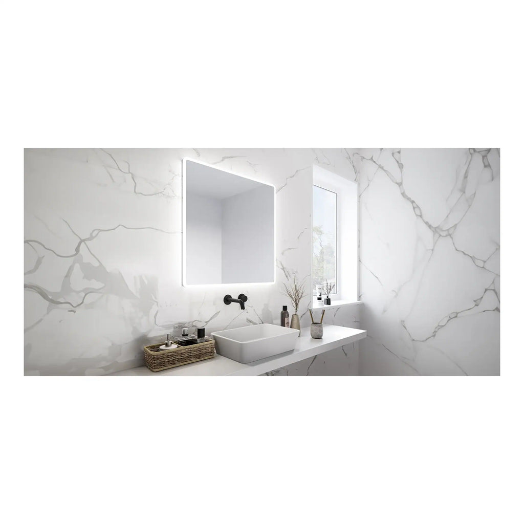 Bright white marble bathroom with modern sink, LED-lit mirror, black fixtures, and natural light from the window, showcasing sleek bathroom design and luxurious finishes.