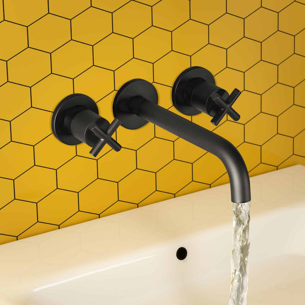 Sleek black wall-mounted bathroom tap with water flowing, set against a vibrant yellow hexagon tiled wall, perfect for modern bathroom design.