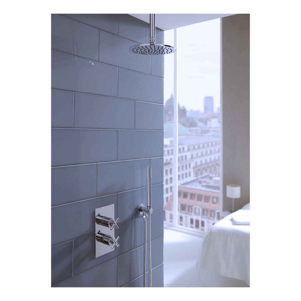 Sleek modern shower with chrome fixtures, large rain shower head, and grey tiled wall in contemporary bathroom design. Perfect for a stylish, functional shower space.