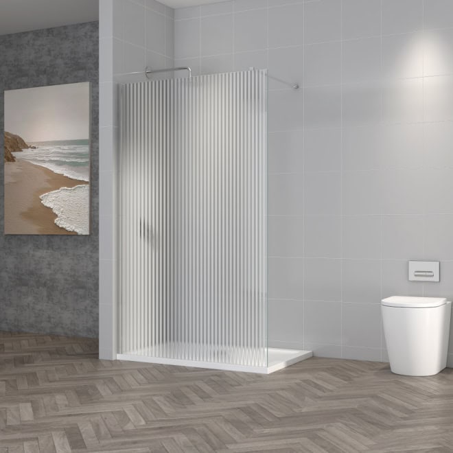 Clear glass shower screen in modern bathroom with grey tiled walls and white toilet, showcasing stylish Bubly Bathrooms shower enclosure and fixtures.