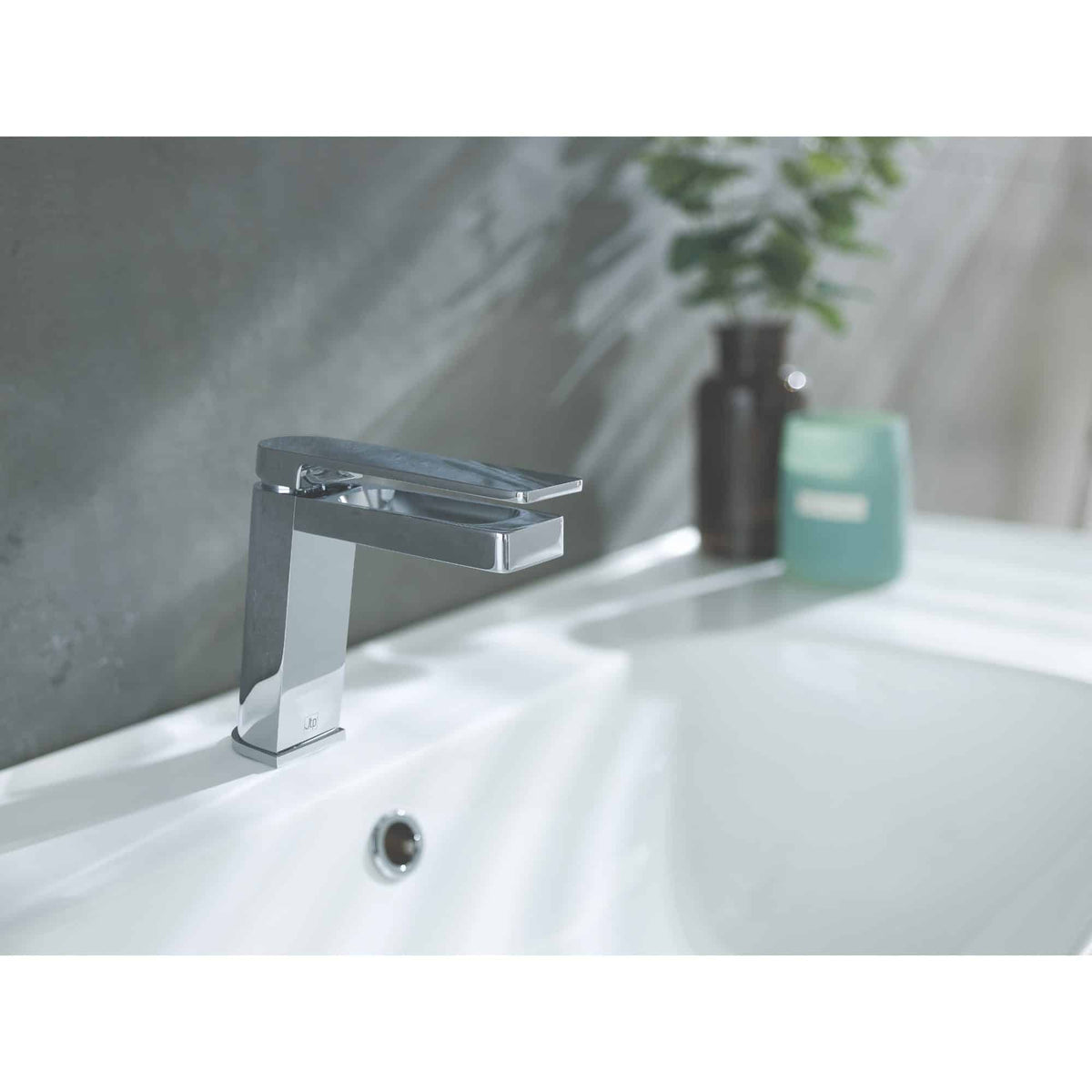 Polished chrome bathroom tap installed on a clean white sink with a modern, minimalist design, showcasing high-quality bathroom fixtures and hygienic surfaces.
