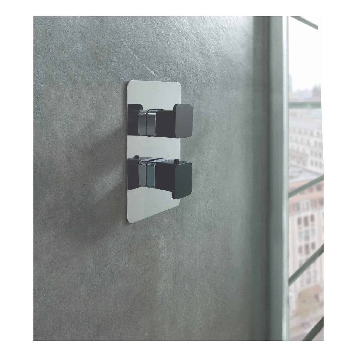 Modern black and chrome bathroom light switch with sleek square design, installed on textured grey wall near large window, showcasing contemporary bathroom lighting fixtures and design.
