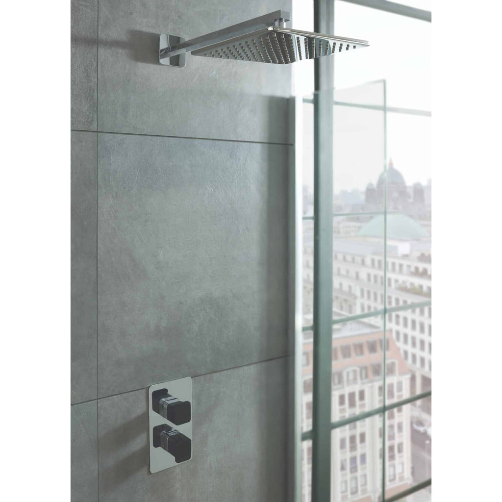 Showerhead and control panel with city view in modern bathroom, showcasing stylish bathroom fixtures and tiled wall design.