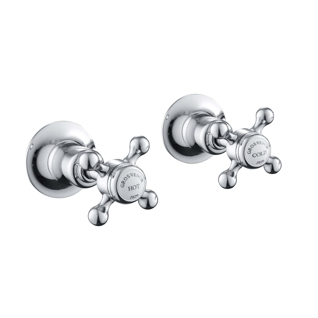 Shiny chrome bathroom hot and cold tap handles with vintage style, perfect for classic bathroom fittings and plumbing fixtures.