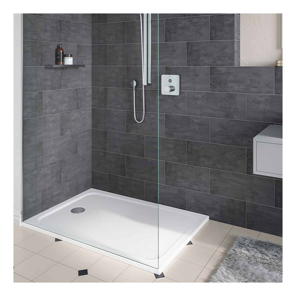 Modern walk-in shower with dark grey tiled walls, minimalist chrome fixtures, and a glass partition, ideal for contemporary bathroom designs. Perfect for sleek, easy-to-maintain Bubly Bathrooms installations.