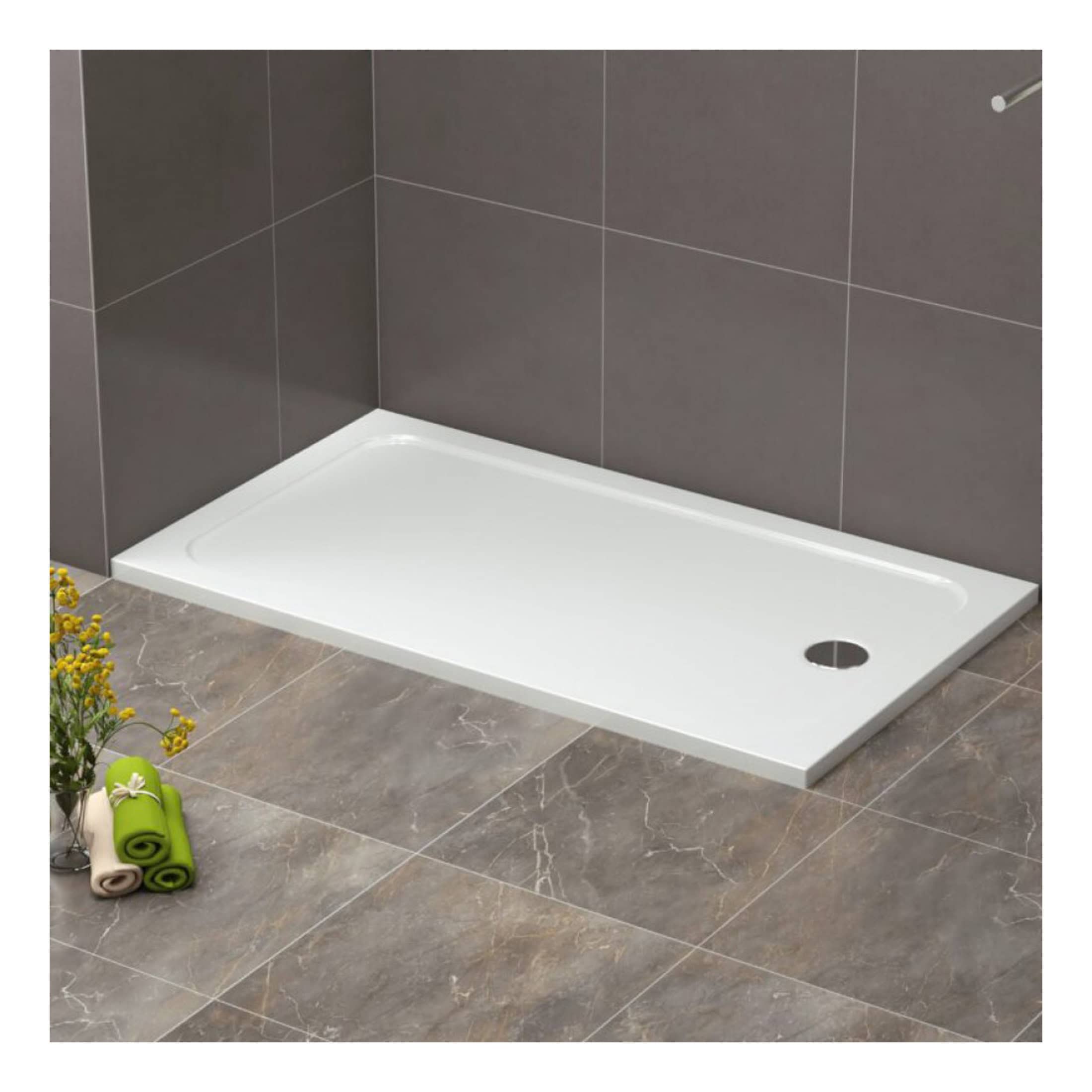 Modern white shower tray fitted against grey tiled bathroom wall, with nearby rolled towels and decorative flowers. Perfect for contemporary bathroom renovations and shower area installations.