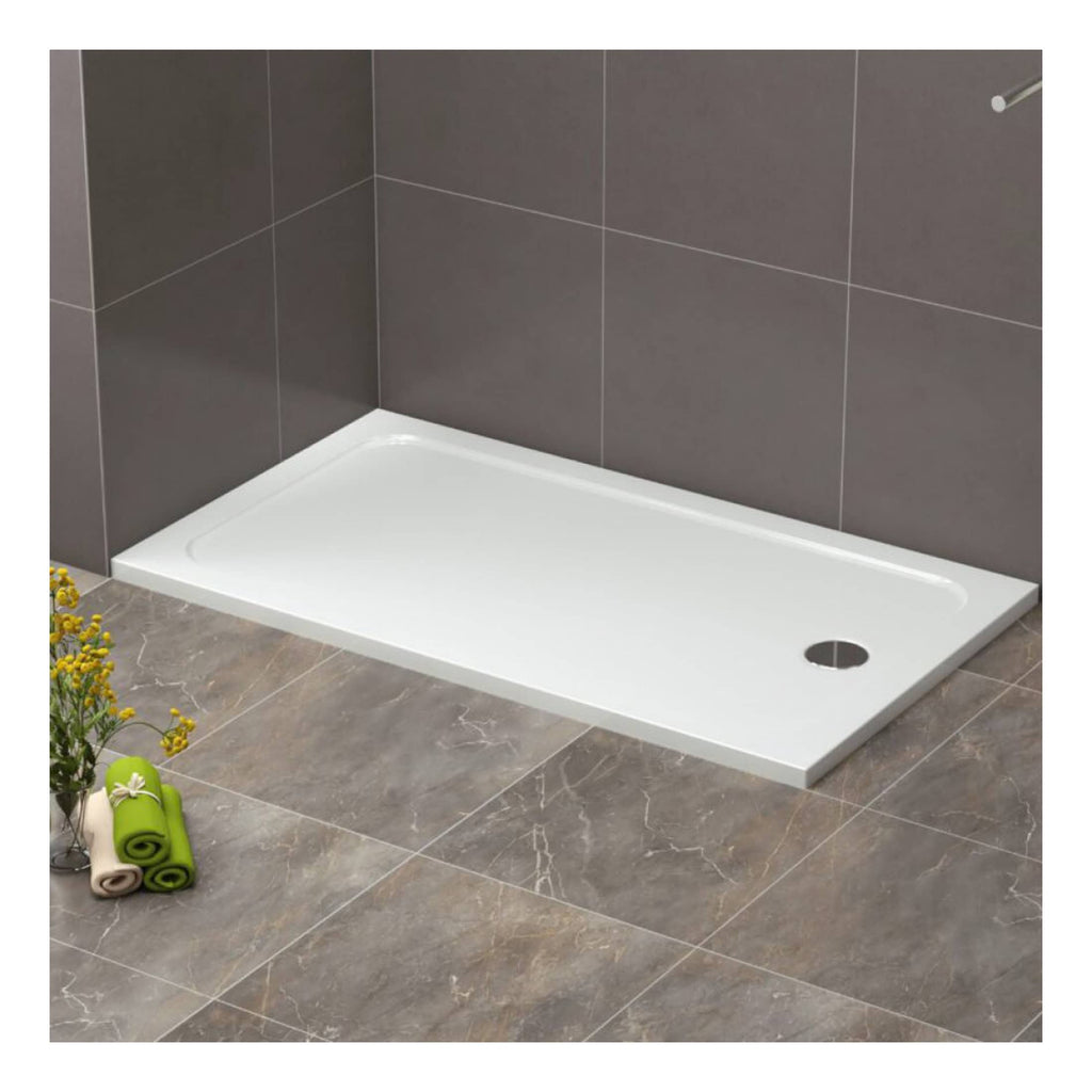 Modern white shower tray fitted against grey tiled bathroom wall, with nearby rolled towels and decorative flowers. Perfect for contemporary bathroom renovations and shower area installations.