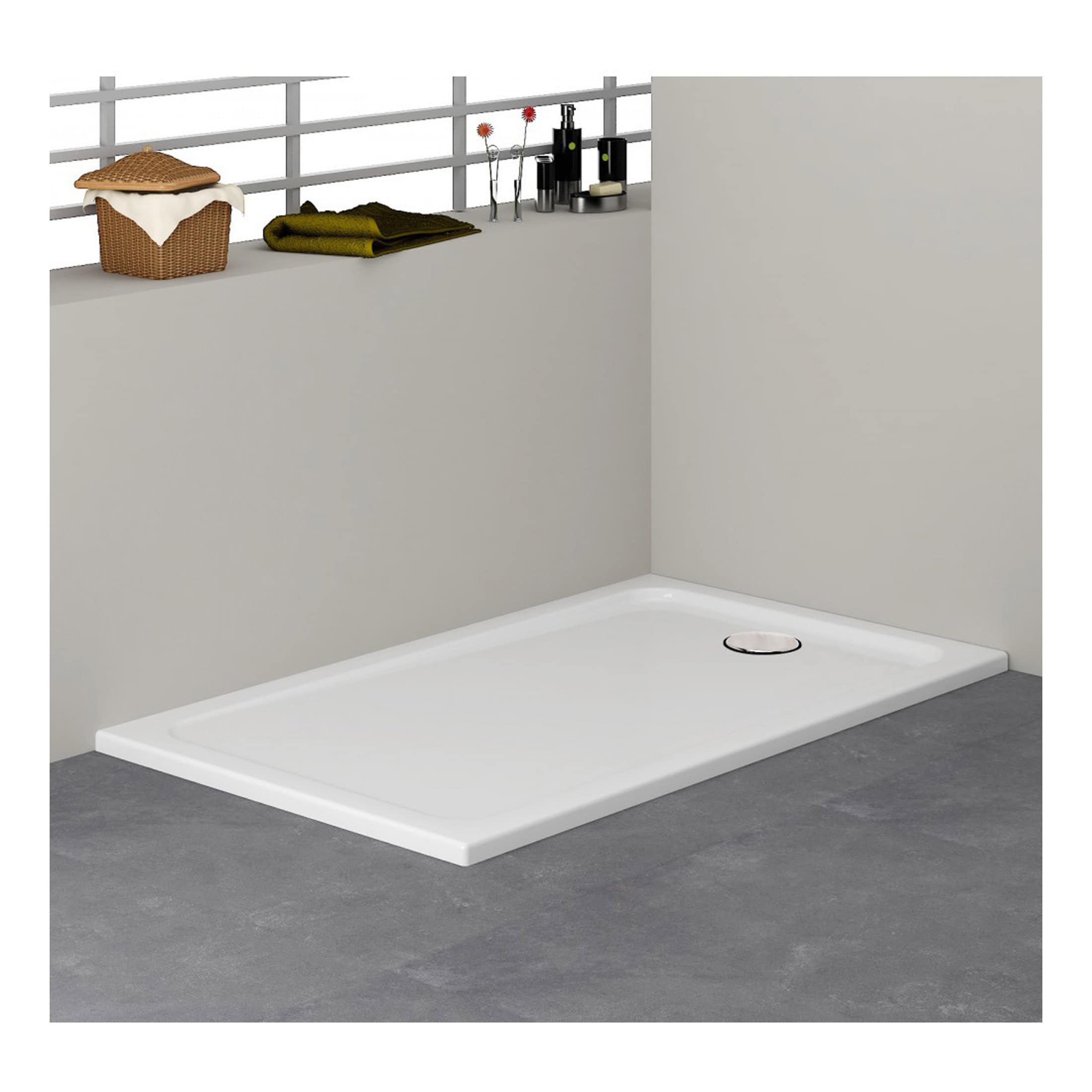 Shower tray with a white finish, installed on a grey tiled floor in a modern bathroom setting. The shower tray features a round drain and is adjacent to a partial wall with a shelf holding bathroom accessories.