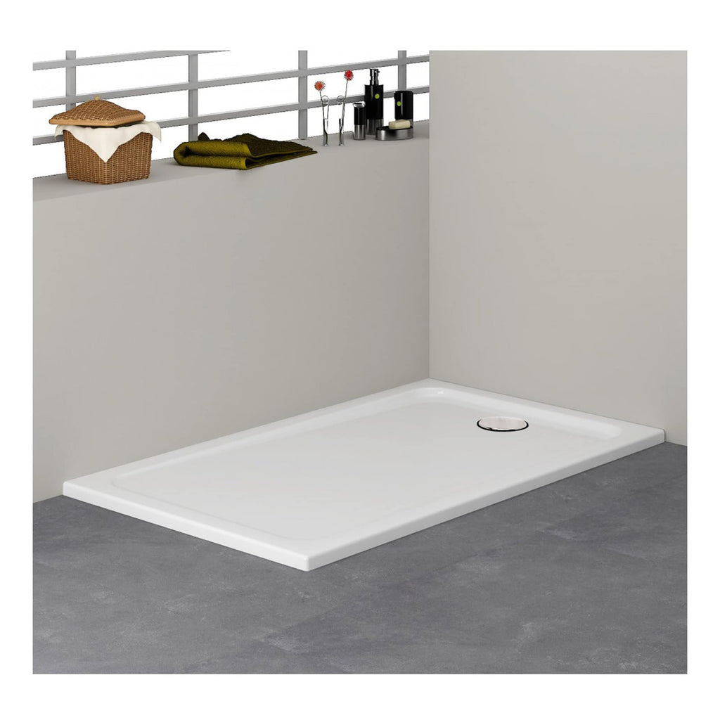 Shower tray with a white finish, installed on a grey tiled floor in a modern bathroom setting. The shower tray features a round drain and is adjacent to a partial wall with a shelf holding bathroom accessories.