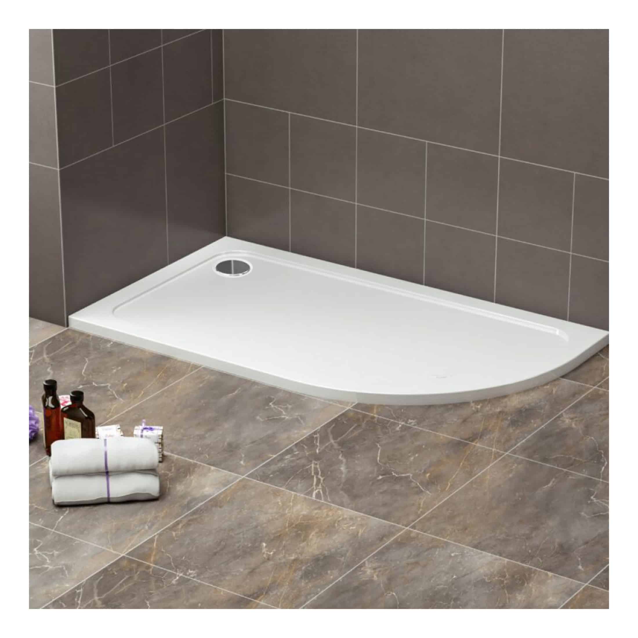 Modern white shower base with integrated waste outlet in a contemporary bathroom setting. Suitable for custom shower enclosure installation in stylish bathrooms.