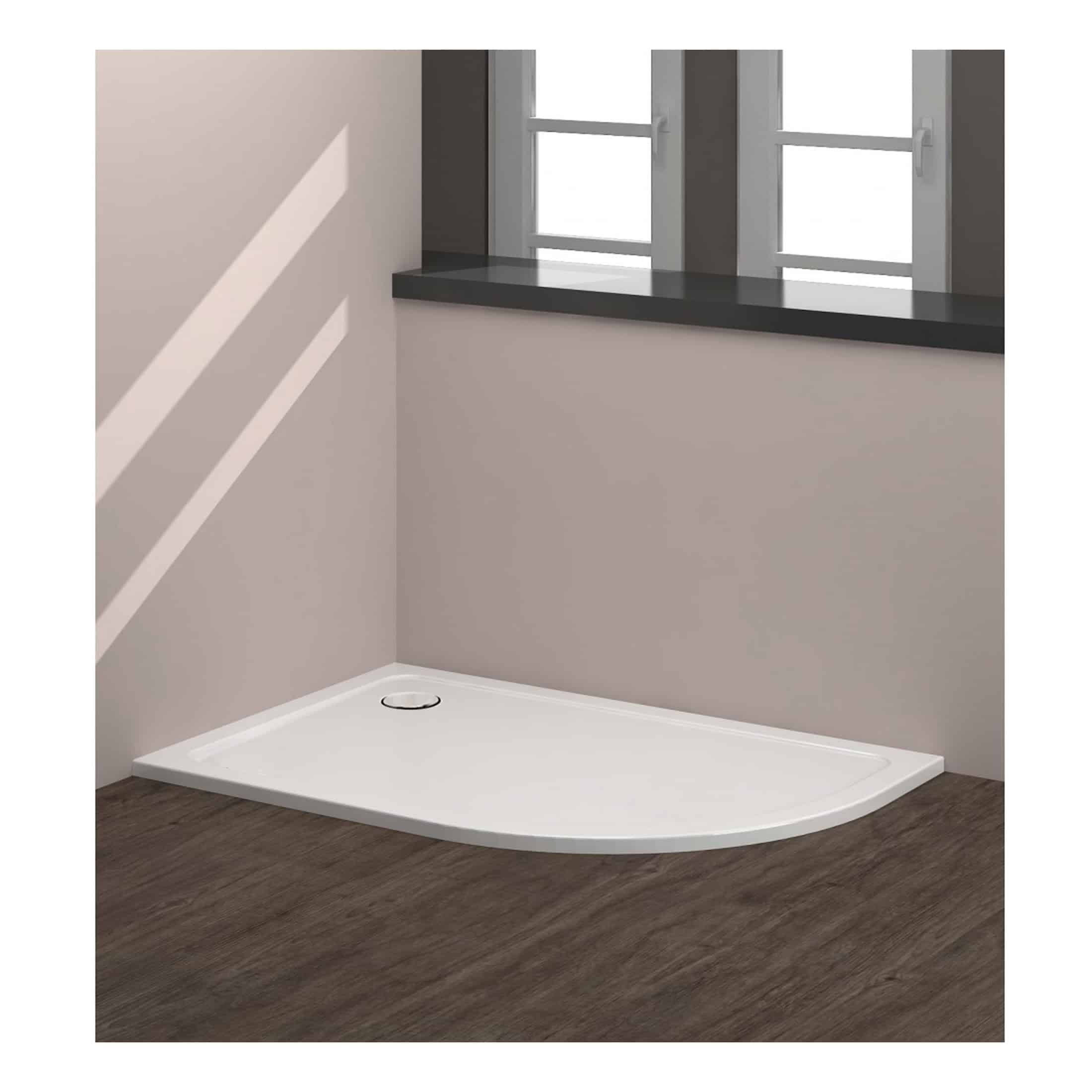 Modern white shower tray on a wooden floor with a grey windowsill and soft pink walls, offering a sleek and functional bathroom shower solution.