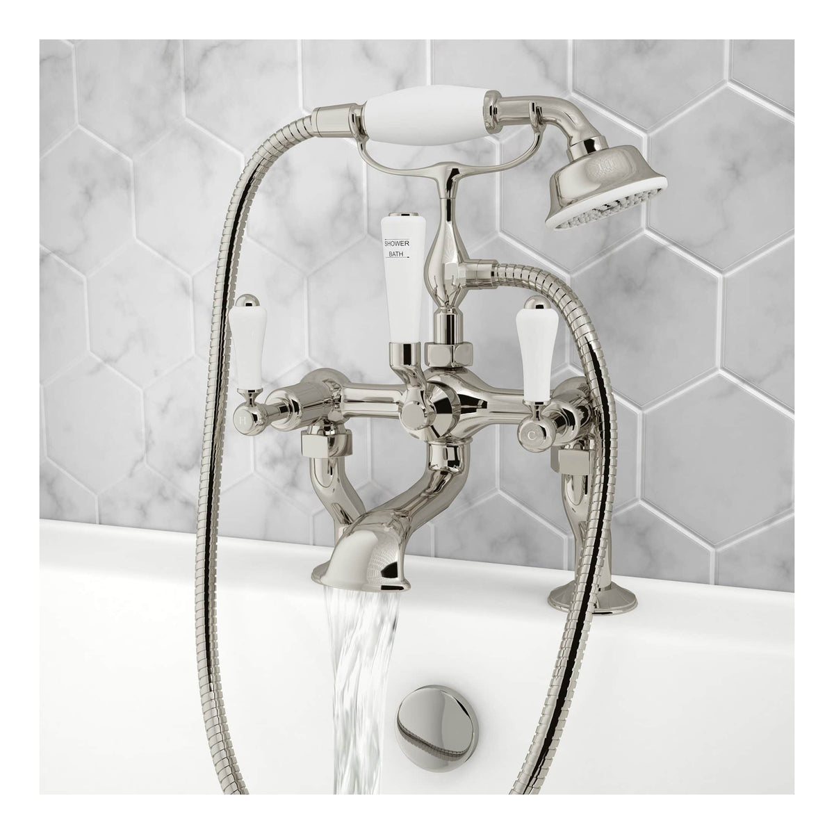 Shiny chrome bathtub mixer tap with handheld shower attachment and white control handles, mounted on a white bathtub with a modern tiling background for stylish bathroom decor.