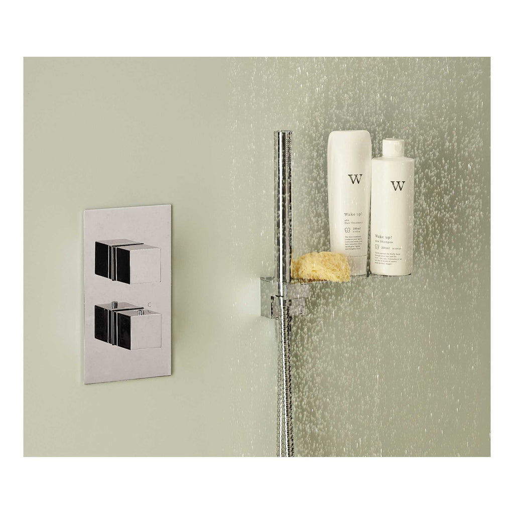 Shower head with adjustable water flow and chrome finish, mounted on a modern bathroom wall with a built-in shower shelf holding shampoo, conditioner, and a sponge for luxury bath experience.