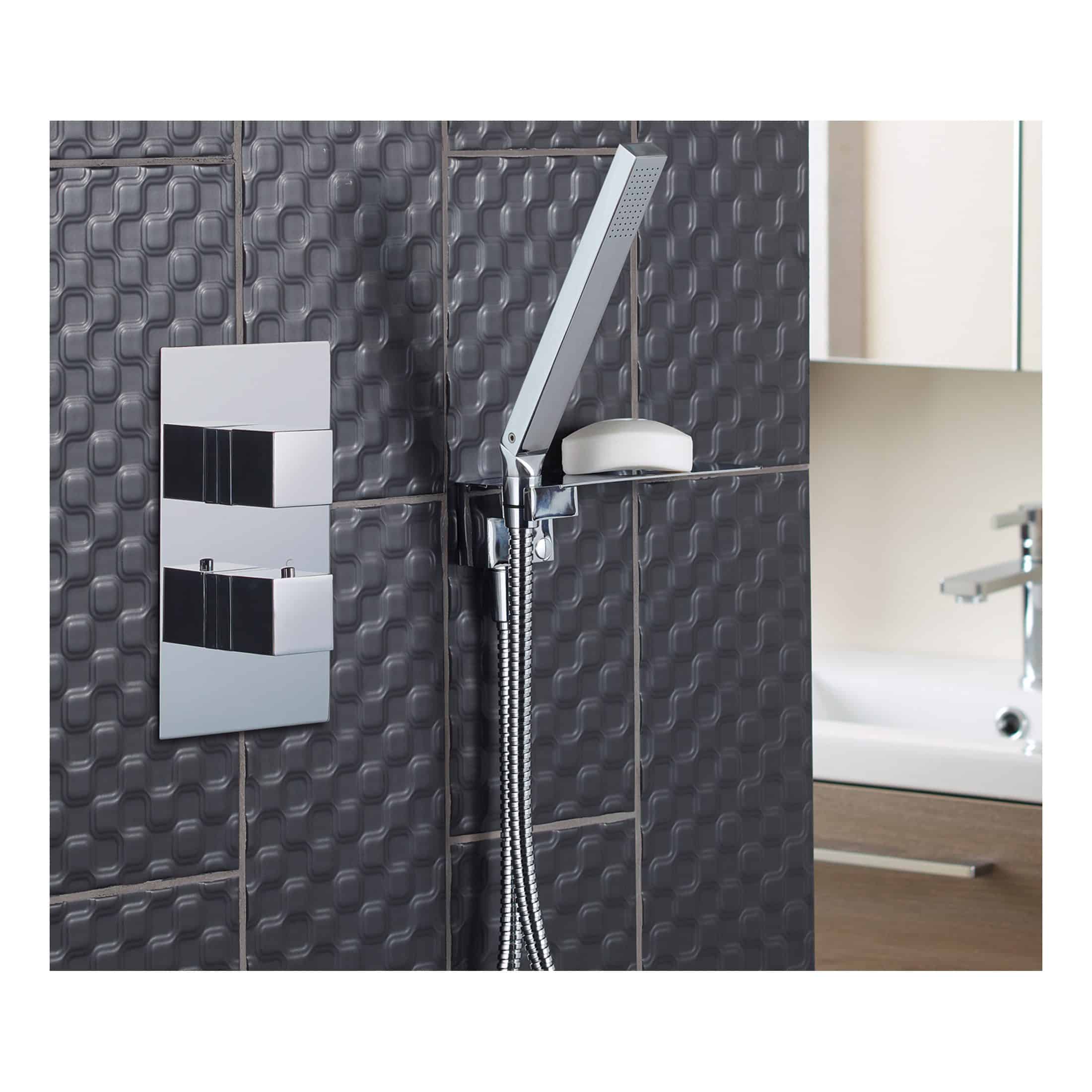 Shower head and controls installed on a textured dark grey tiled bathroom wall, featuring modern fixtures for a stylish and functional contemporary bathroom design.