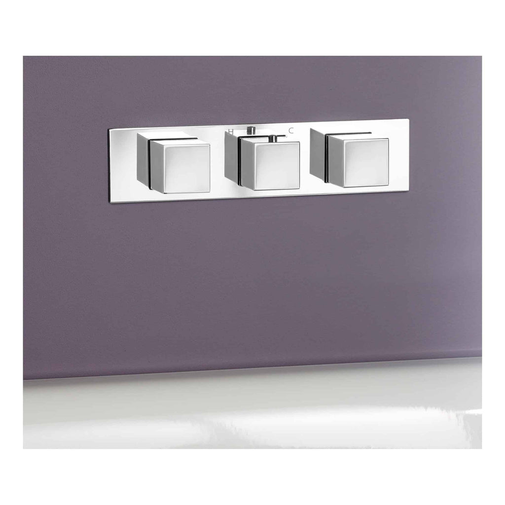 Switch plate with three square rocker switches on a modern purple wall for bathroom lighting control.